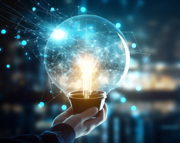 Hand holding a glowing lightbulb, representing innovation